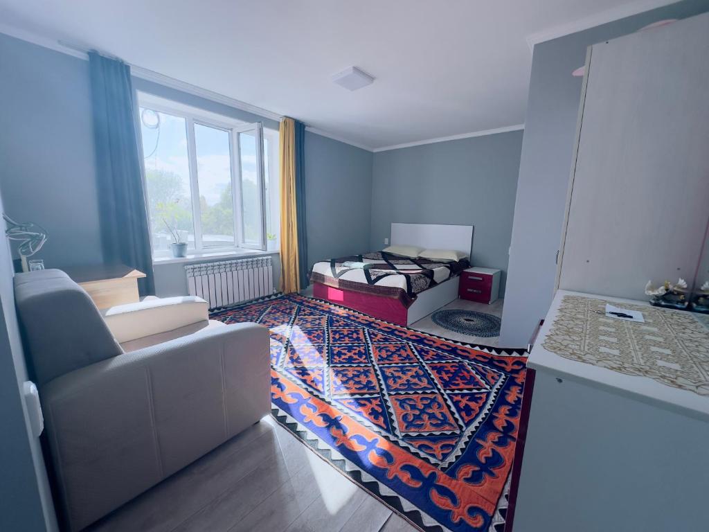 Zimmer mit 2 Betten, einem Sofa und einem Fenster in der Unterkunft Guest house B&B in Kochkorka