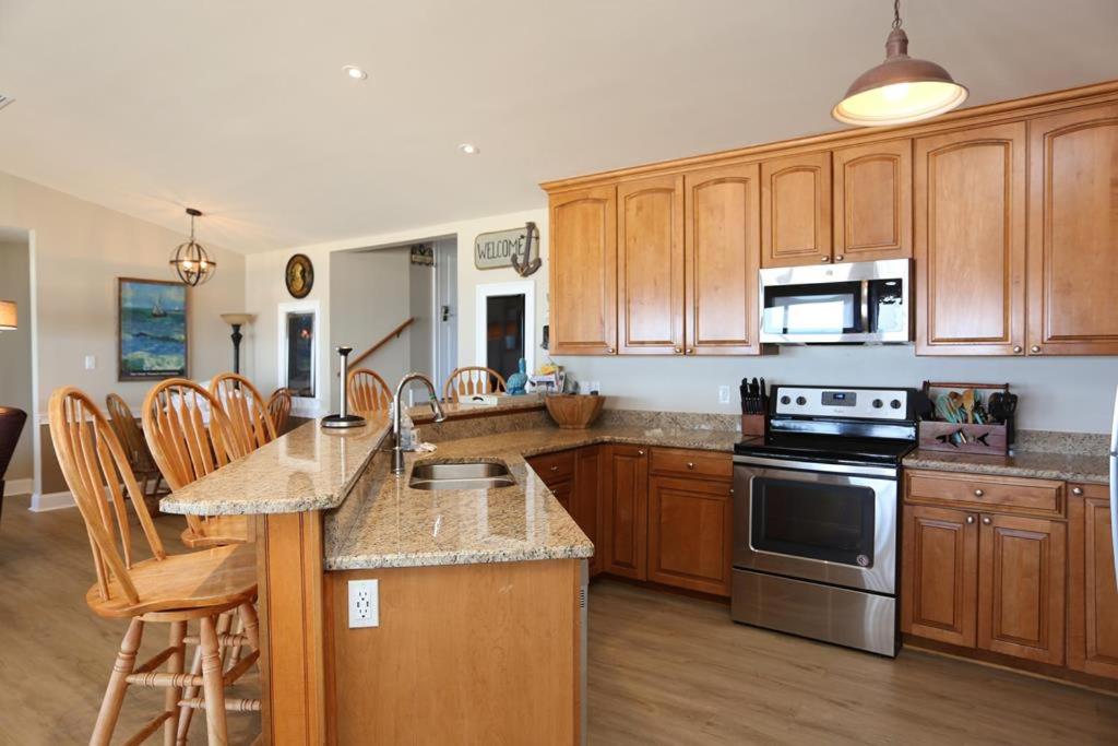 a kitchen with wooden cabinets and a stove top oven at Buckleys Beach House by Pristine Property Vacation Rentals in Indian Pass