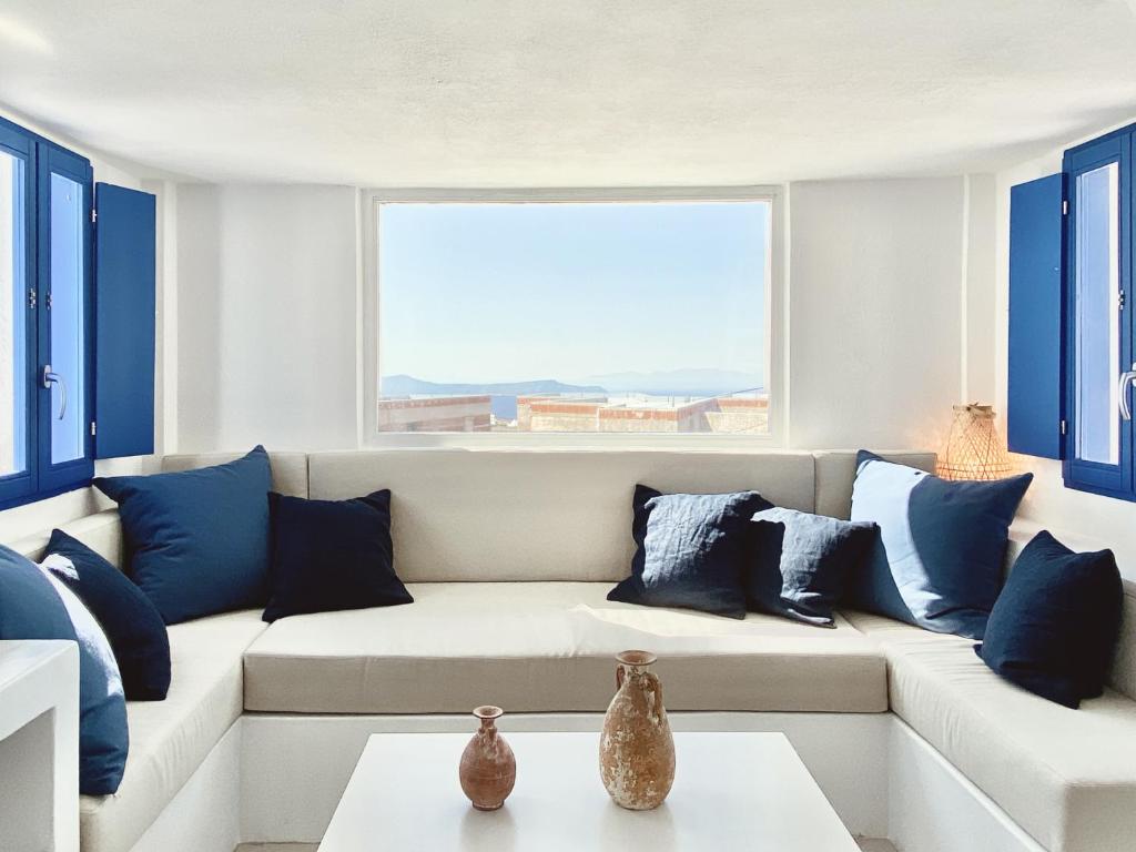 Sunset Pyrgos في بيرغوس: غرفة معيشة مع أريكة مع وسائد زرقاء