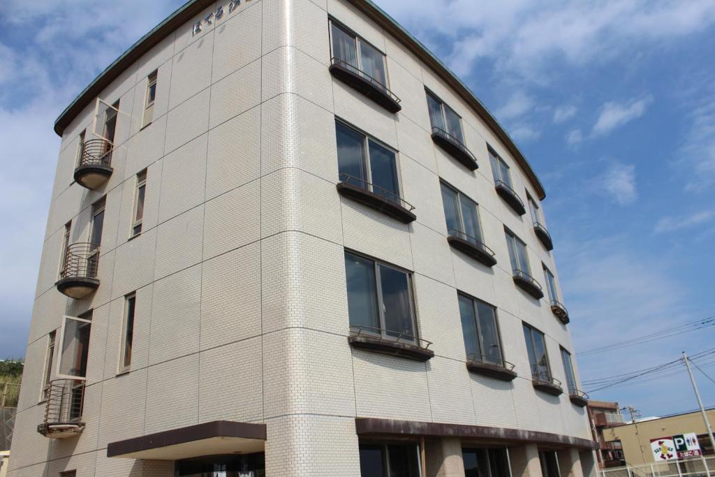 a tall building with windows on the side of it at Hotel Shiosai in Fujisawa