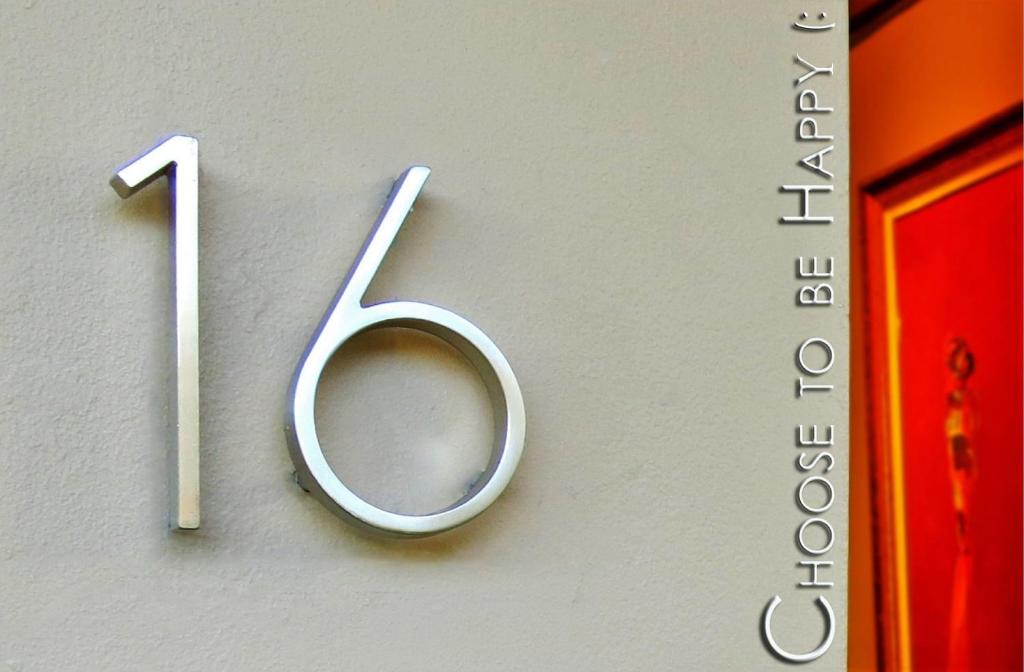 a metal number on a wall with the number seven at Choose To Be Happy at Seymour # 9 and #16 - Studio Apartments in Kingston