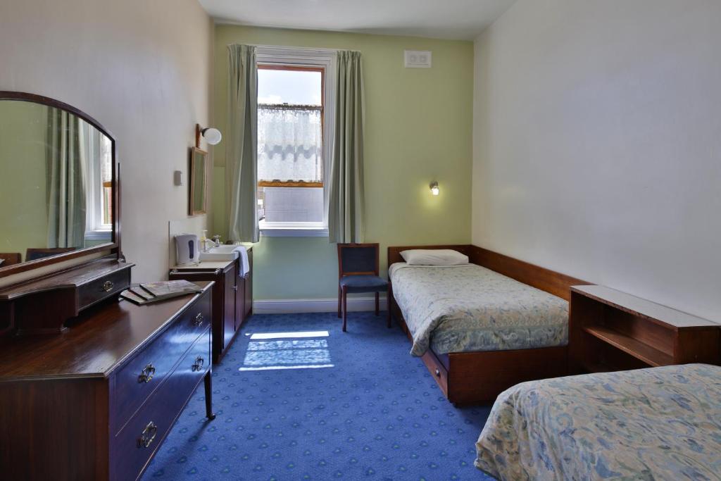 Postel nebo postele na pokoji v ubytování Astor Private Hotel