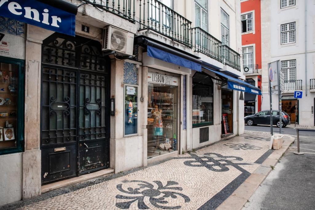 a street with shops on the side of a building at Olivier Premium Apartments - Downtown Lisbon in Lisbon