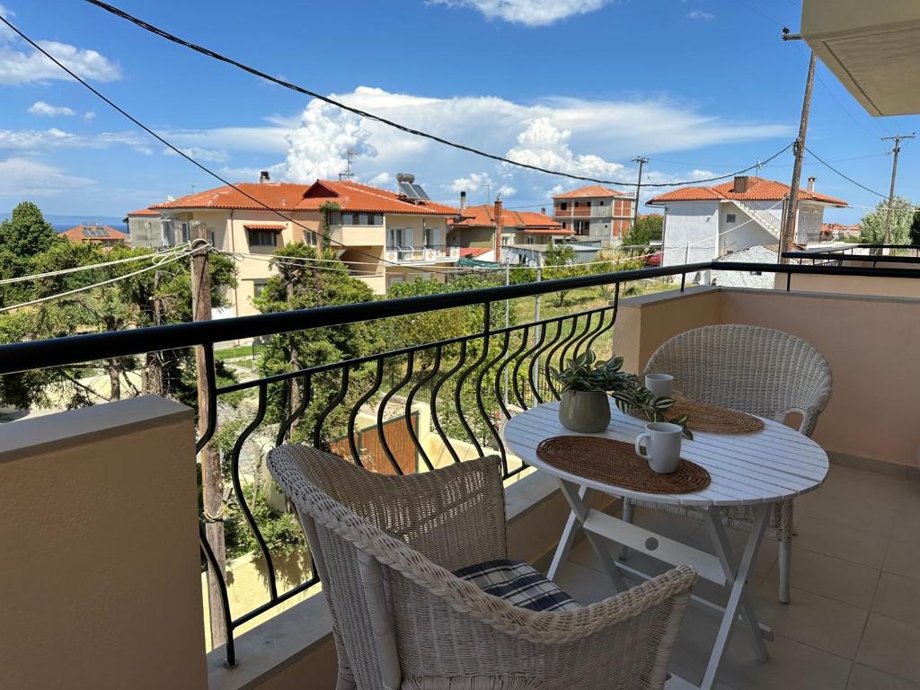 a balcony with a table and chairs on a balcony at Sunnyside Suite Afytos in Afitos