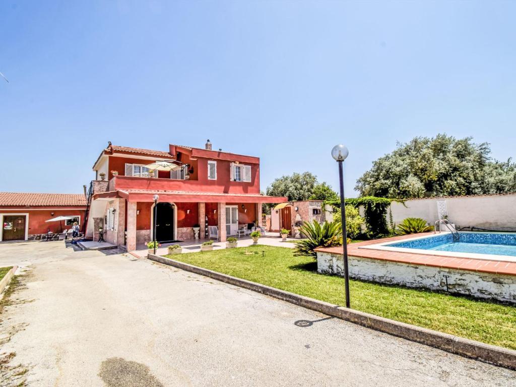 an exterior view of a house with a swimming pool at Apartment White Pool by Interhome in Siracusa