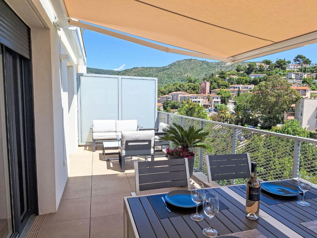 a patio with a table and chairs on a balcony at Apartment Indigo Bay by Interhome in Le Lavandou