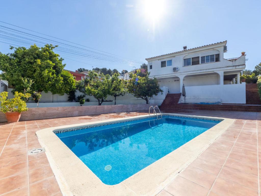 a swimming pool in front of a house at Holiday Home Cibada by Interhome in Pobla de Montornés