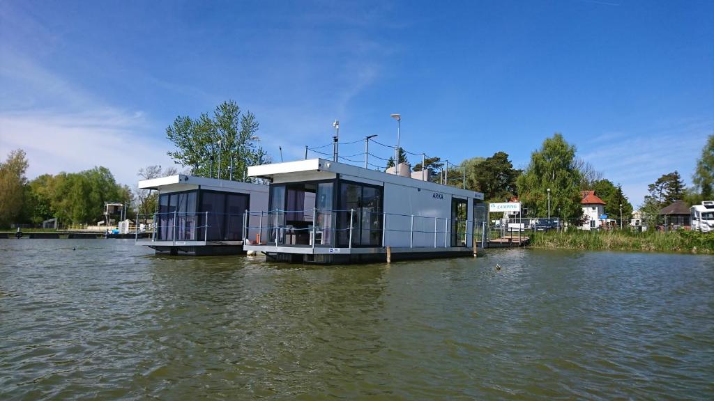 a building in the middle of a body of water at ARKA 1 domki na wodzie w Mielnie, rower wodny, bezpłatny WIFI, Parking in Mielno