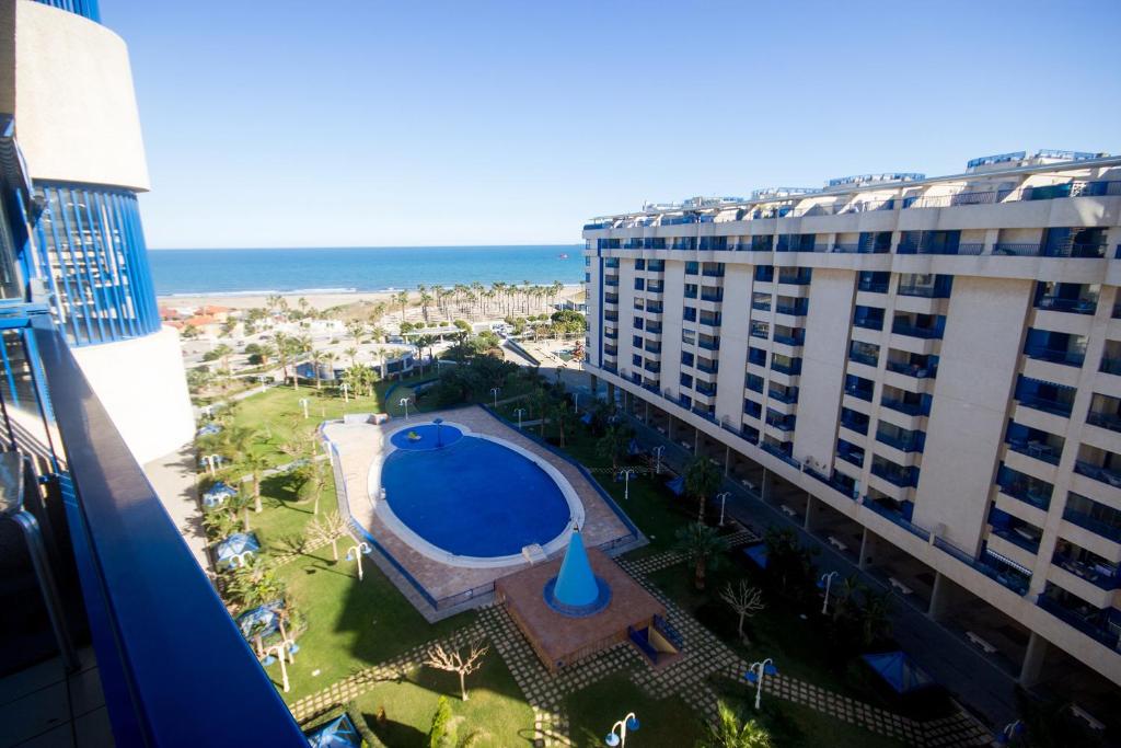 an aerial view of a resort with a pool and the ocean at Patacona deluxe primera linea in Valencia