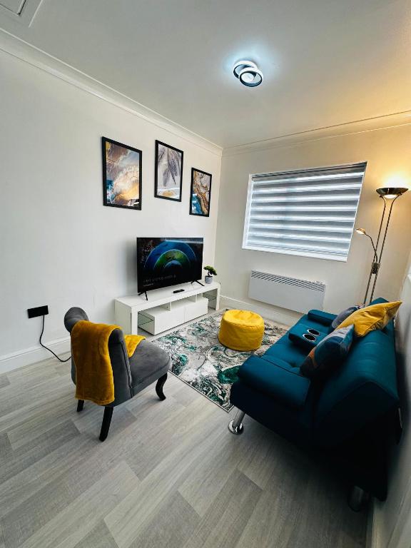 a living room with a blue couch and a television at Cozy Haven Your Perfect 1Bed LE2 in Leicester