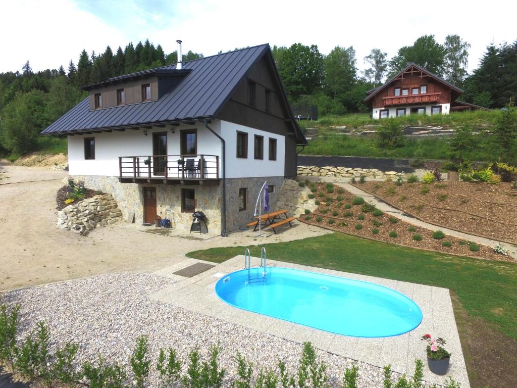 an aerial view of a house with a swimming pool at Chalupa Jizerka in Plavy