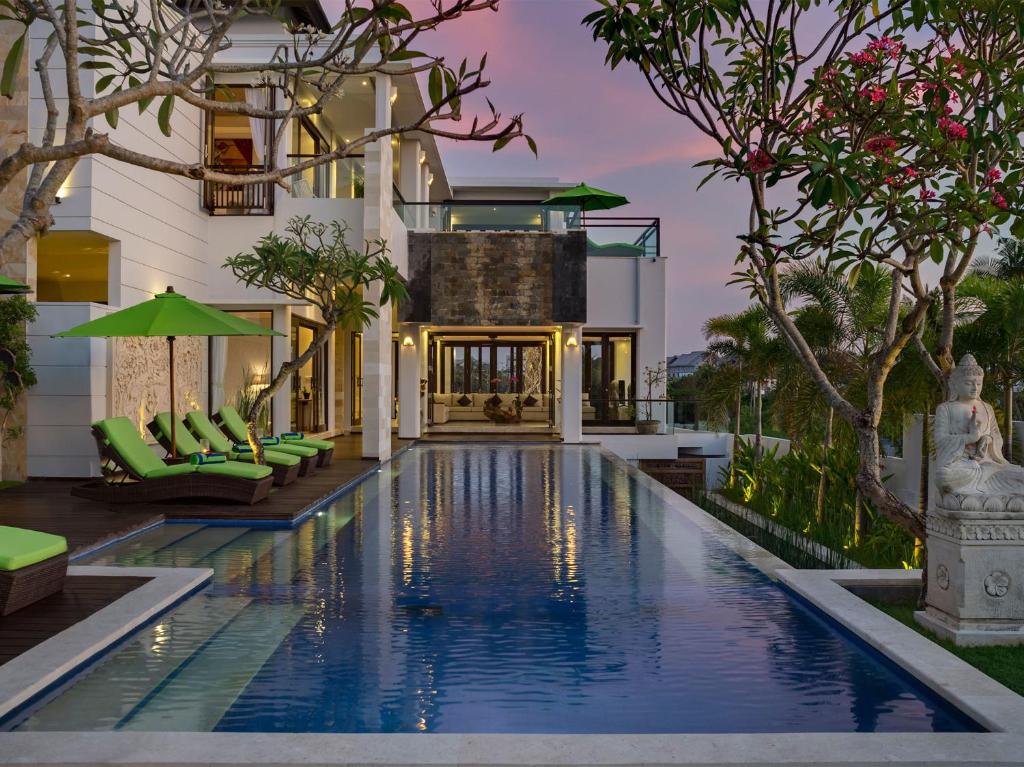 a swimming pool in front of a villa at Villa Luwih in Canggu