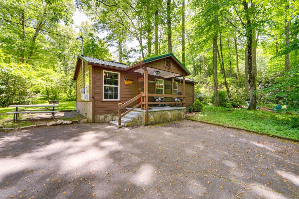 a small cabin in the woods with a driveway at Pet-Friendly Maggie Valley Cabin with Pool Access! in Maggie Valley