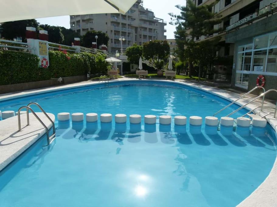 ein großer blauer Pool in einem Gebäude in der Unterkunft Salou, Port Aventura, piscina, a 80m del mar in Salou