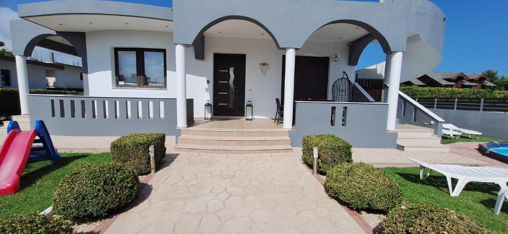 a house with a pathway leading to the front door at Rhodian Villa in Kremasti