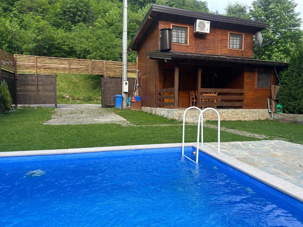 a swimming pool in front of a house at Paradise on the Vrbas River in Jajce
