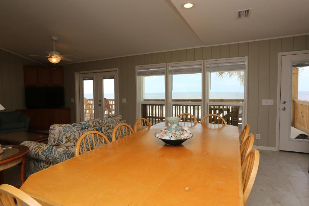 a dining room with a wooden table and chairs at One More Time Again by Pristine Properties Vacation Rentals in Mexico Beach