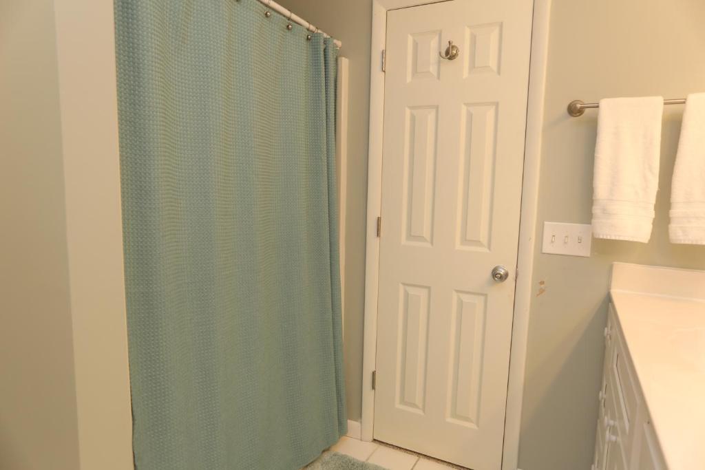 a shower with a blue shower curtain in a bathroom at One More Time Again by Pristine Properties Vacation Rentals in Mexico Beach