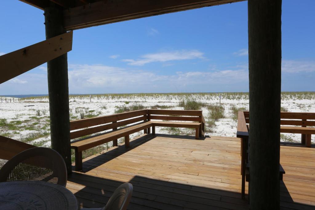 a wooden porch with a view of the beach at One More Time Again by Pristine Properties Vacation Rentals in Mexico Beach