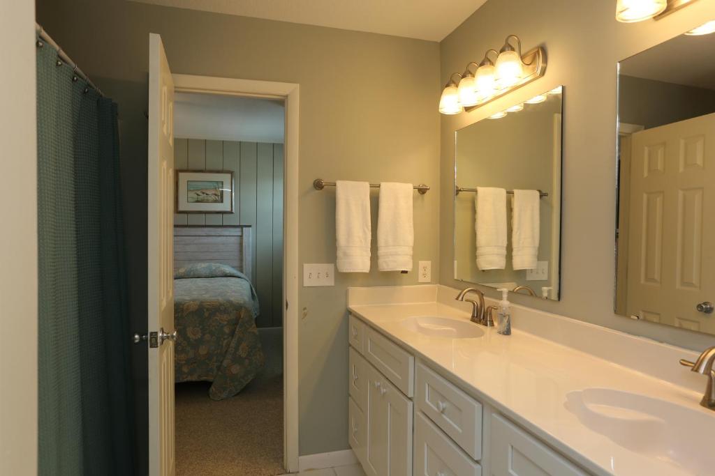 a bathroom with two sinks and a mirror at One More Time Again by Pristine Properties Vacation Rentals in Mexico Beach