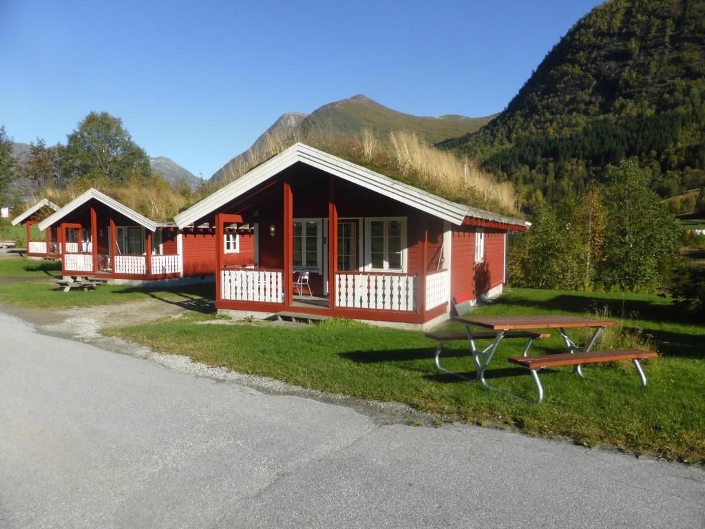 a group of cottages with a picnic table in front at Skei Servicenter in Skei