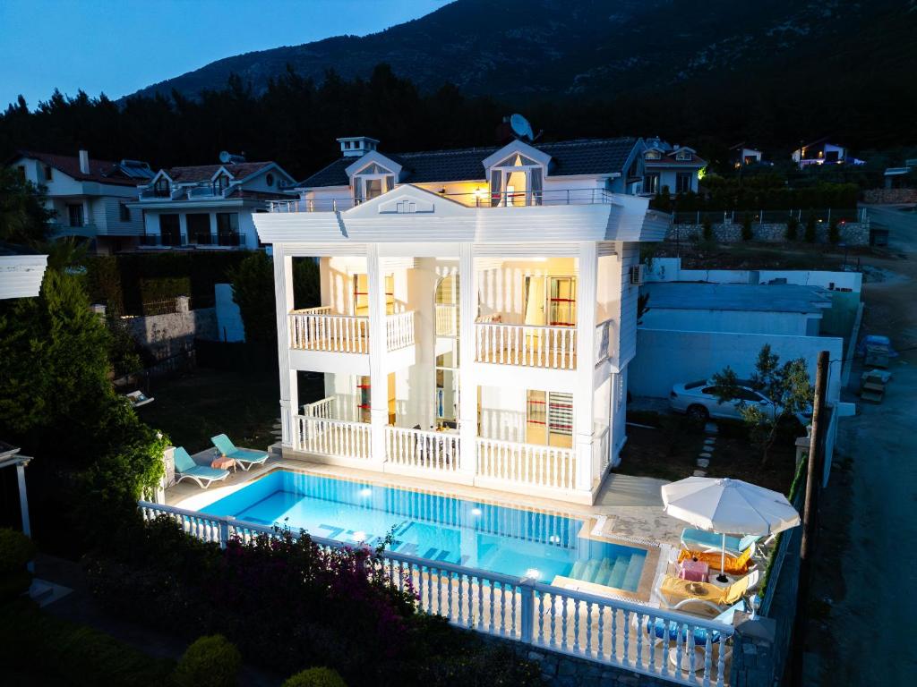 an aerial view of a house with a swimming pool at Villa Angel - Private Pool and Nature View in Ölüdeniz in Fethiye