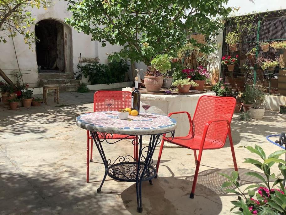 een tafel met 2 stoelen en een tafel met een fles wijn bij Casa Las Almenillas in Antequera