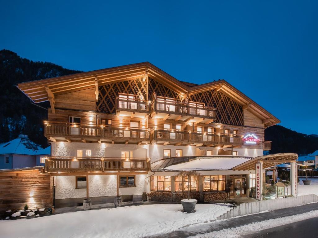 a large building in the snow at night at Hundehotel Riederhof in Ried im Oberinntal