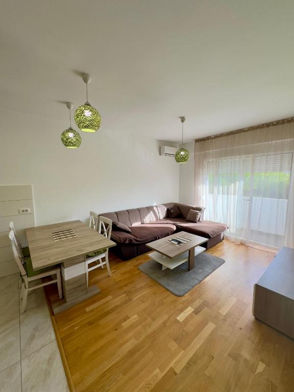 a living room with a couch and a table at Cozy 1 bedroom APT with free parking in Podgorica