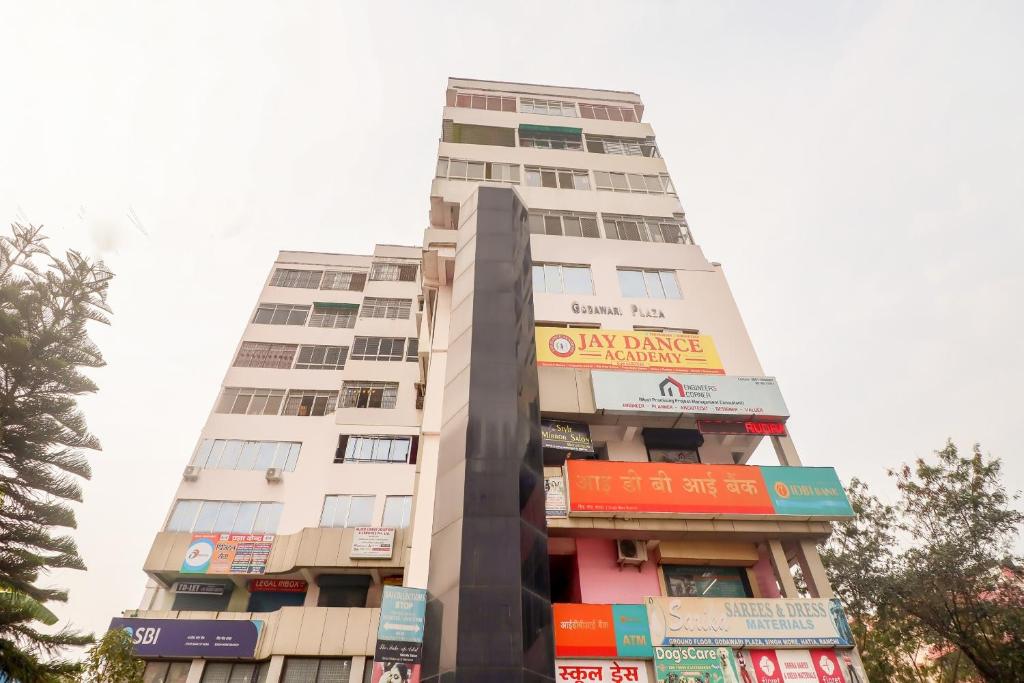 a tall building with colorful signs on it at Hotel RUDRA INN in Rānchī