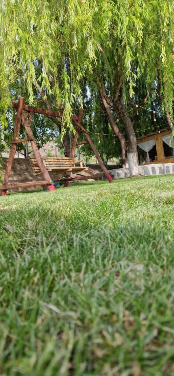 a playground in a park with trees and grass at GreenField Luxe in Yeghegnadzor