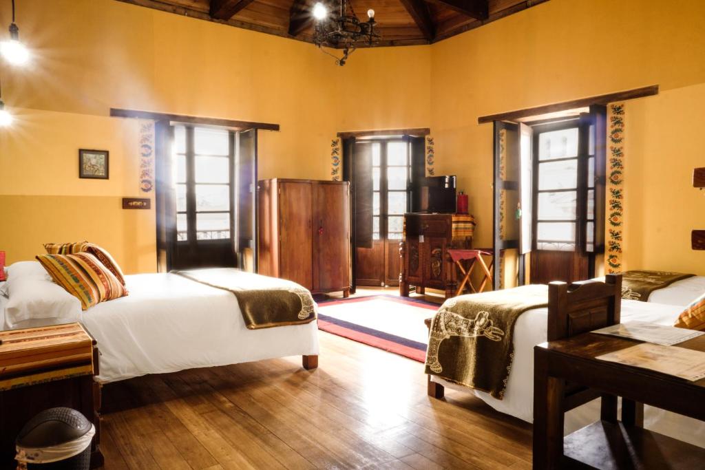 Postel nebo postele na pokoji v ubytování Hotel Casa Alquimia