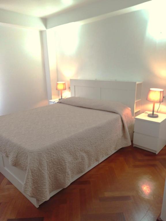 a bedroom with a bed and two lamps on tables at Mallorca Town Center Lovely Apartment in Palma de Mallorca