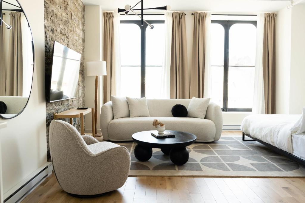 a living room with a couch and a chair and a table at Maison Place Jacques-Cartier by Luxury In Transit in Montréal