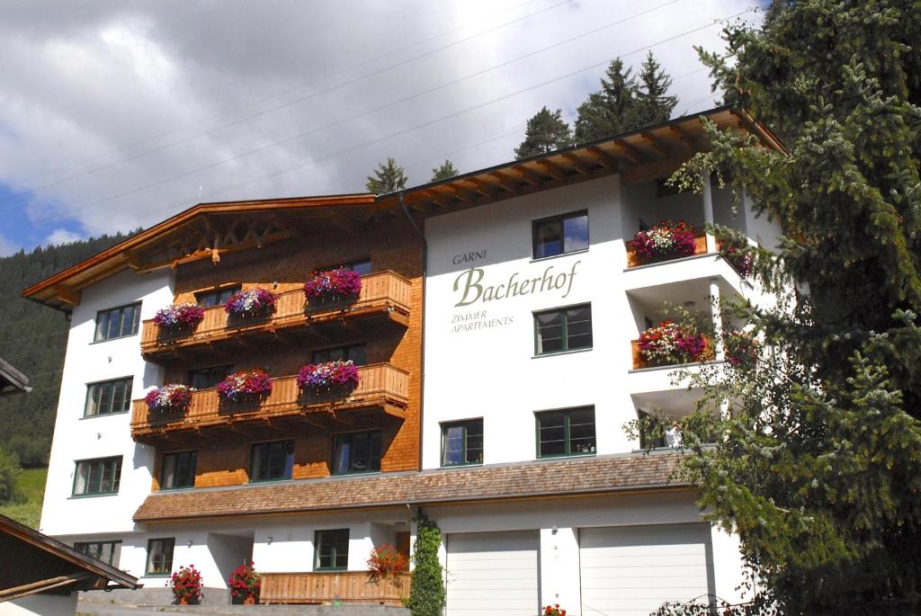 a building with flower boxes on its windows at Bacherhof in Sankt Anton am Arlberg