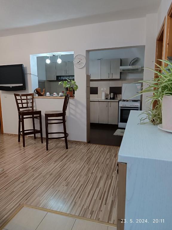 a kitchen and living room with a table and chairs at 3-Bedroom NewHome in Mostar