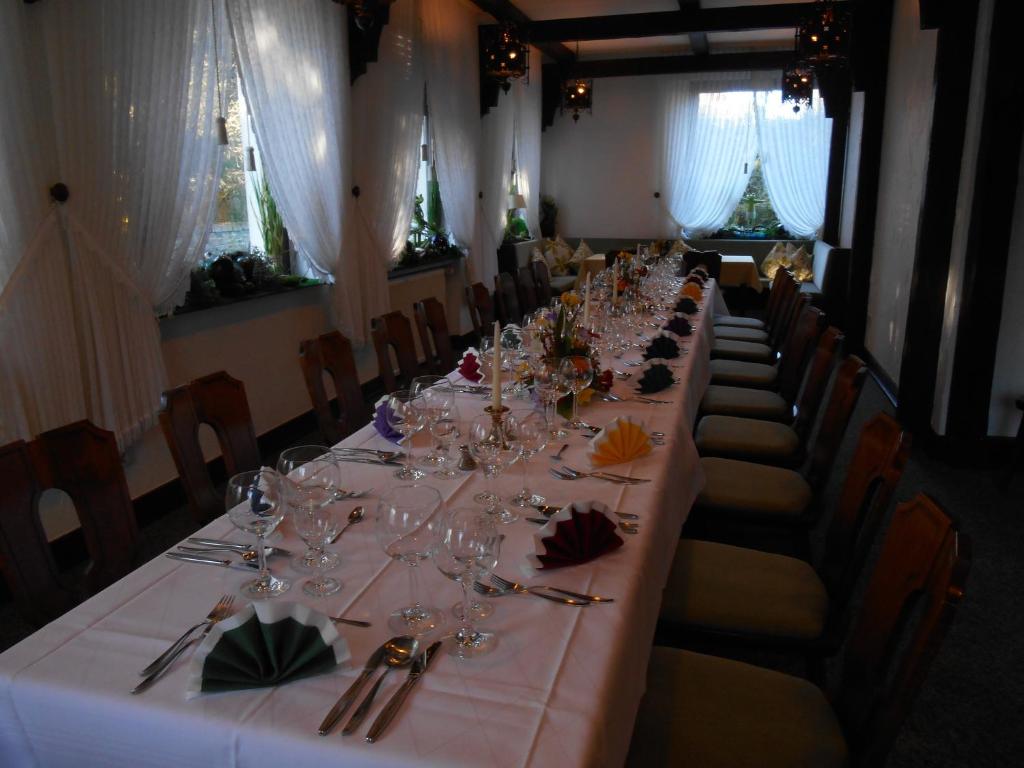 a long table with wine glasses in a room at Haus Von Der Heyde in Iserlohn