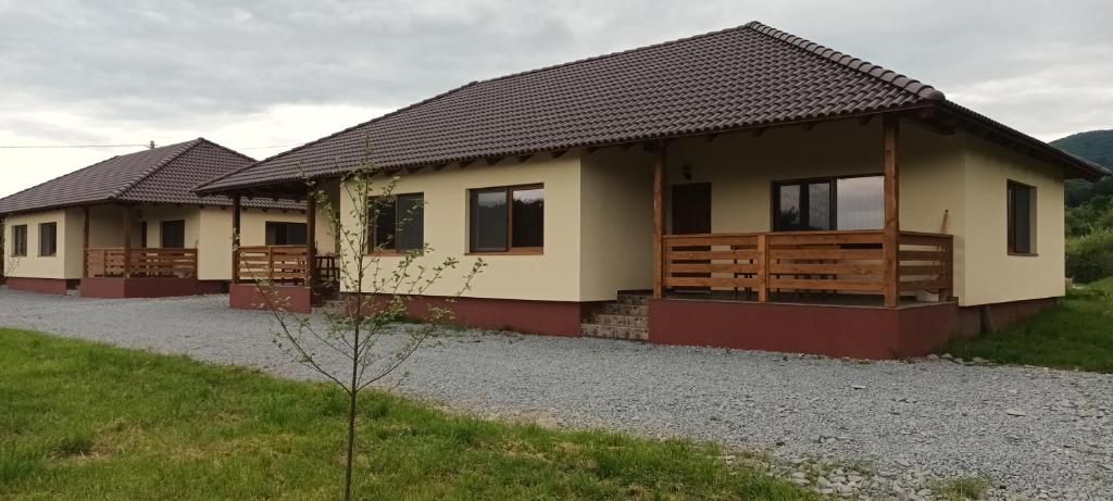 a small house with a gravel driveway at Betula Apartman in Sovata