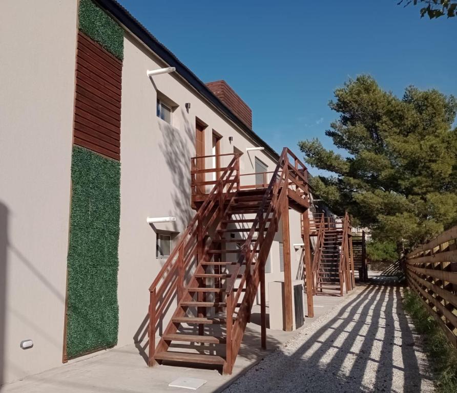 a group of wooden stairs on the side of a building at Village de Mar in Monte Hermoso