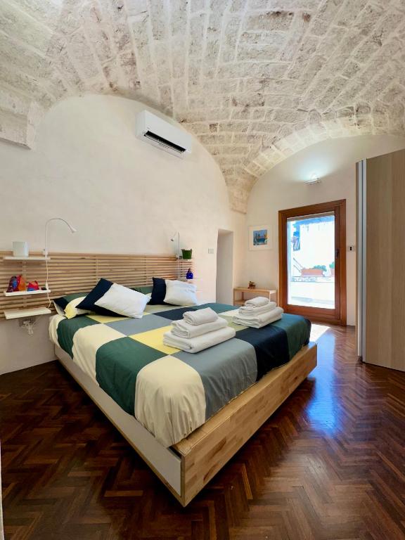 a bedroom with a large bed in a room at Tangram Ostuni Apartment in Ostuni