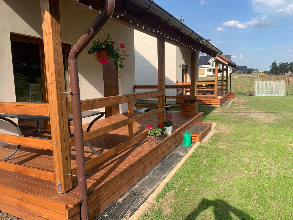 a porch of a house with a wooden deck at Domki Wieleń in Wielen Zaobrzanski