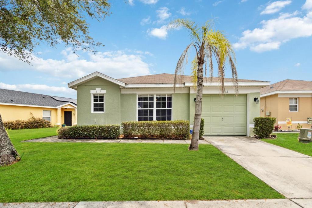 a palm tree in front of a house at Villa Del Sol in Davenport