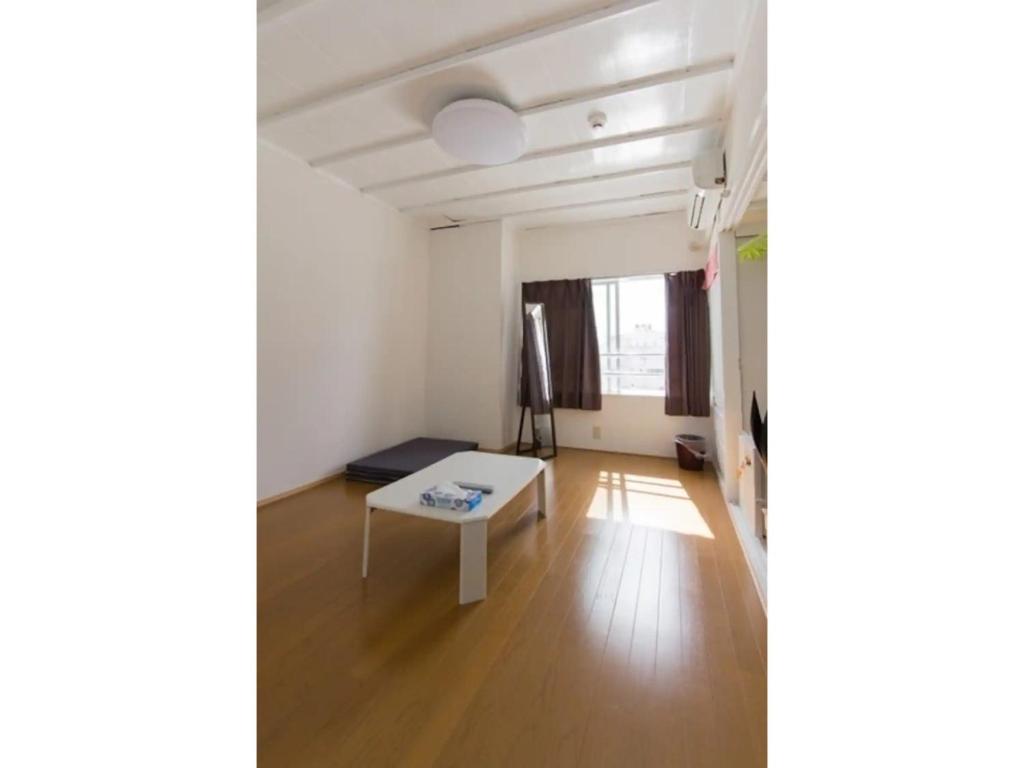 a living room with a white table in a room at OYADO YAMASASHI - Vacation STAY 16886 in Ishigaki Island