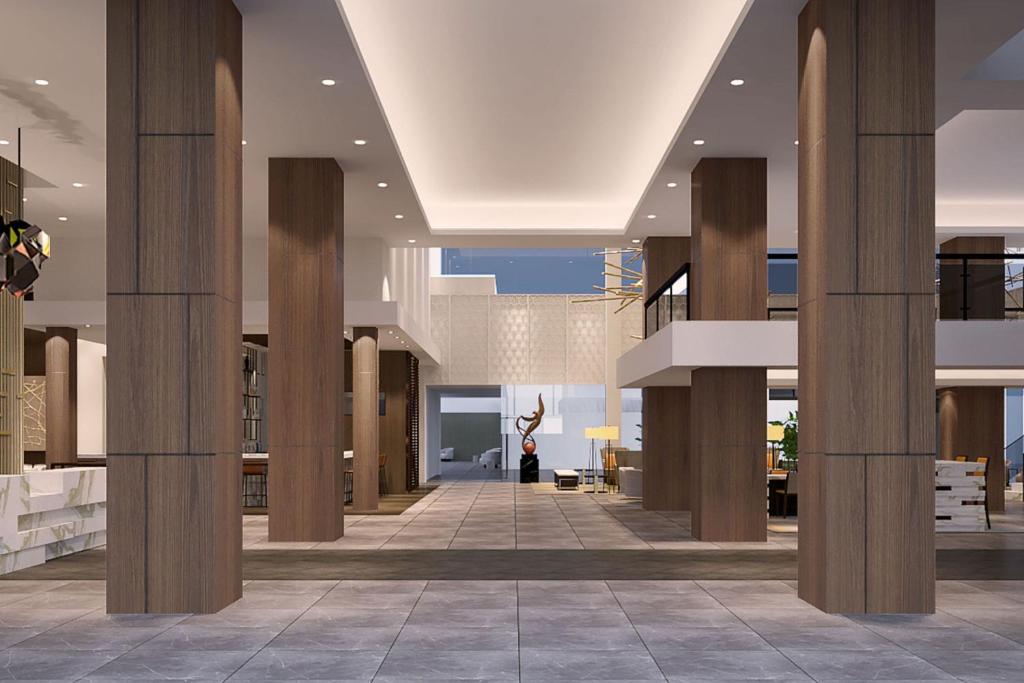 a lobby with columns and a staircase in a building at Delta Hotels by Marriott Ontario Airport in Ontario