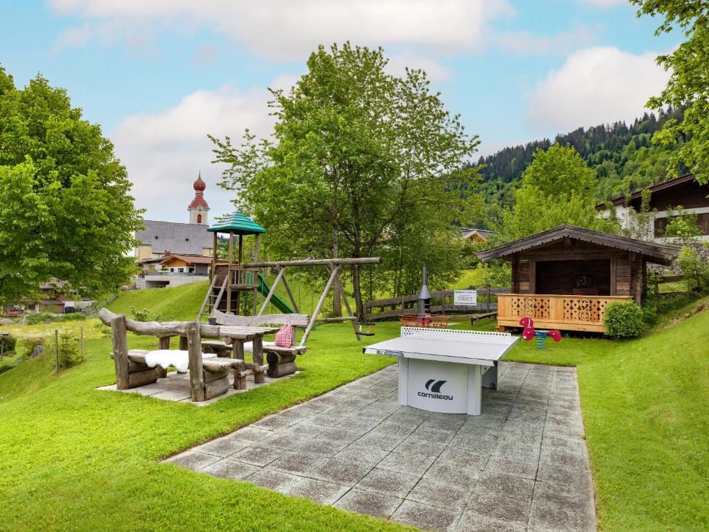 a backyard with a picnic table and a playground at Appartements Schedererhaus in Going