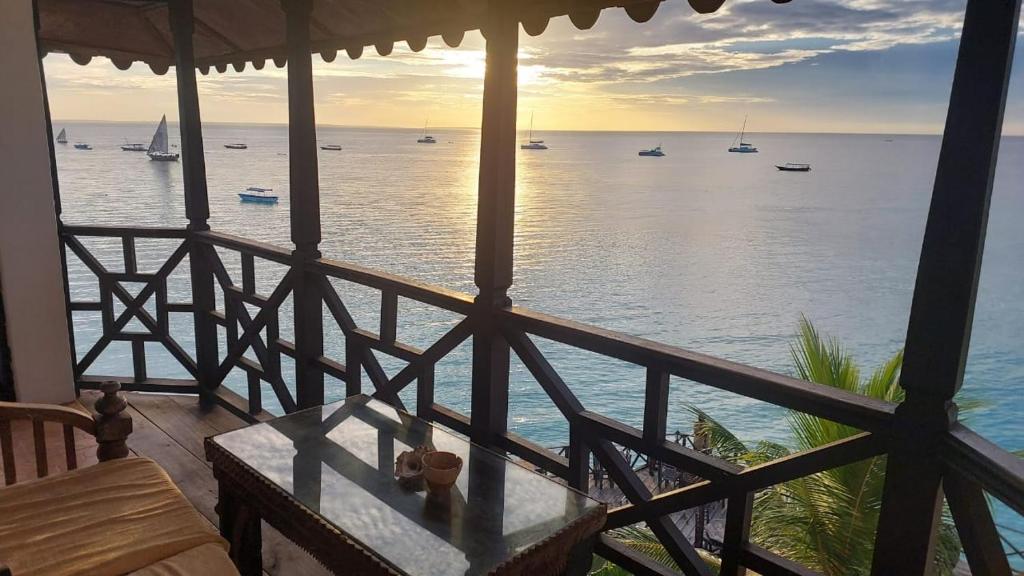 a view of the ocean from a balcony of a house at Langi Langi Beach Bungalows in Nungwi