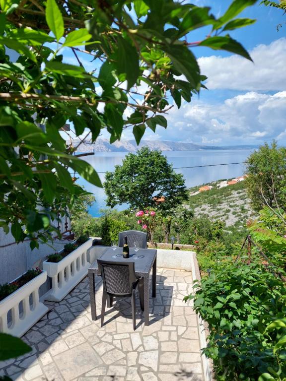 a table and chairs on a patio with a view of the ocean at Dalibor in Senj