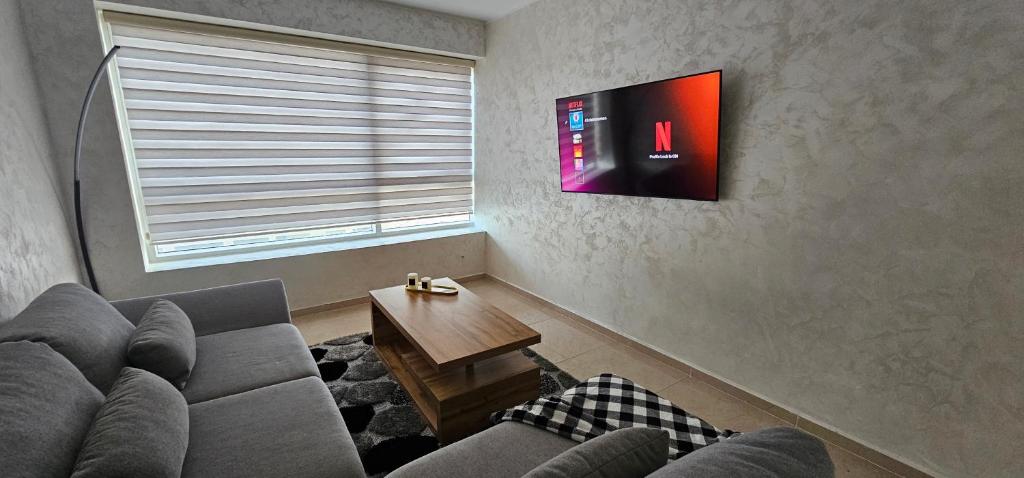 a living room with a couch and a tv at Luxury apartment near TGV station and the beach in Tangier