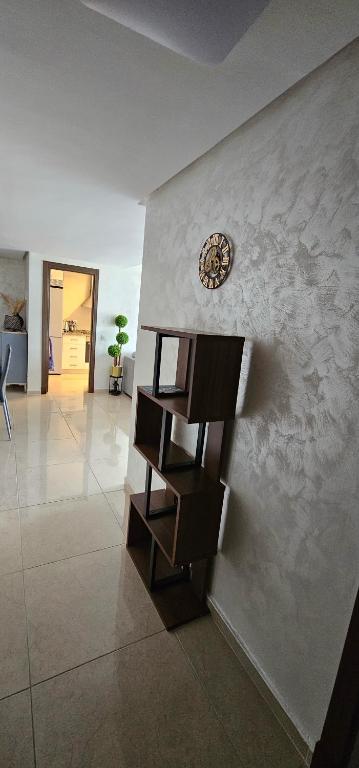a staircase in a room with a clock on the wall at Luxury apartment near TGV station and the beach in Tangier
