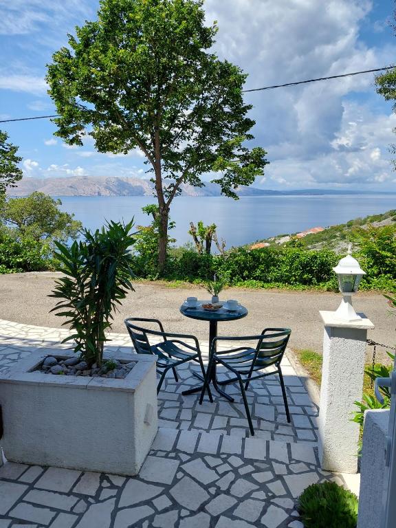 a patio with a table and chairs and the water at Dalibor in Senj